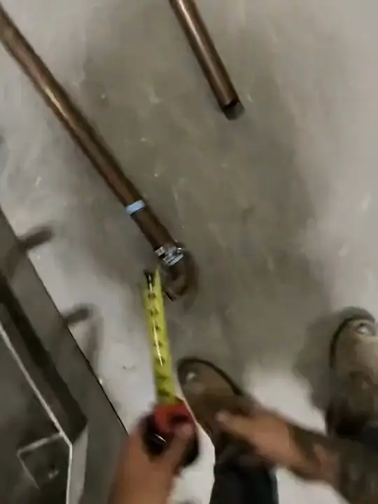 Through Jacob's glasses: a tape measure along copper pipe and an elbow