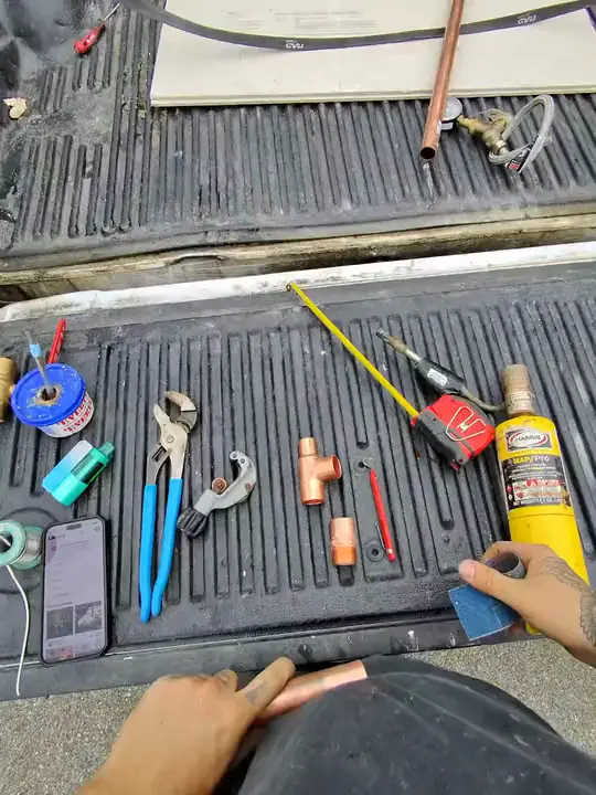Through Jacob's glasses: copper fittings pushed together by hand on a tailgate